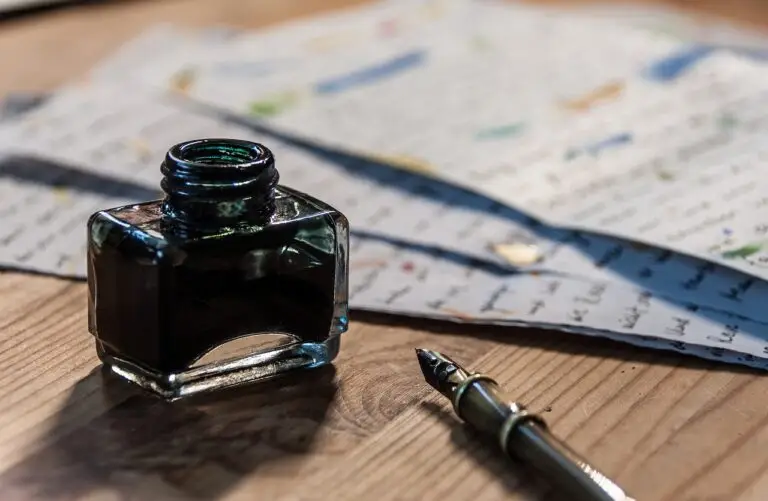Open ink bottle and fountain pen on a desk beside notes — representing ecommerce SEO website optimization services